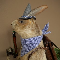 Taxidermied Wolpertinger marmot hiker with hat, backpack, neckerchief, walking stick, and pipe