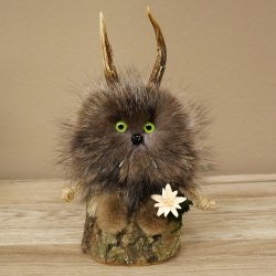 Wolpertinger «Wolpi», modelo mini, sobre base de madera, con flor de las nieves y ojos verdes. Altura: 23 cm. 86.1.3.56